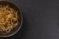 Raw thin noodles on grey stone Royalty Free Stock Photo