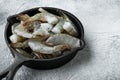 Raw tiger prawns, in cast iron frying pan, on gray stone background Royalty Free Stock Photo