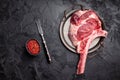 Raw tomahawk steak with marbling, fresh rib eye with bone. black background. top view Royalty Free Stock Photo