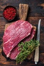 Raw top sirloin cap steak or Picanha steak on wooden board with thyme. Dark wooden background. Top view Royalty Free Stock Photo