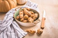 Raw topinambour with pumpkins in bowl on kitchen table