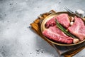 Raw Topside sirloin beef cut on steel plate with spices. Gray background. Top view. Copy space