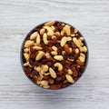 Raw Trail Mix with Nuts and Fruits in a Bowl on a white wooden background, top view. Flat lay, overhead, from above Royalty Free Stock Photo