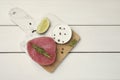 Raw tuna fillet with rosemary, lime wedge and spices on white wooden table, top view. Space for text Royalty Free Stock Photo