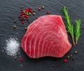 Raw tuna fish steak on natural stone black slate serving plate. Top view Royalty Free Stock Photo