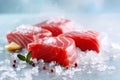 Raw Tuna steaks on crushed ice with red pepper and lemon on light grey background, close up. Fresh tuna fish slices for sashimi,