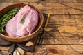 Raw turkey breast fillet, Poultry meat in a wooden plate. wooden background. Top View. Copy space Royalty Free Stock Photo