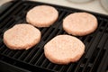 Raw Turkey Burgers on Grill Royalty Free Stock Photo