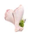 Raw turkey drumsticks and ingredients on white background