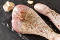 Raw Turkey legs with spices , garlic, on a black , raw meat, close up