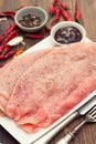 Raw turkey with sauce on white dish Royalty Free Stock Photo