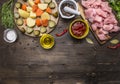 Raw turkey with tomato sauce, pepper, spices, herbs ingredients for stew on wooden rustic background top view close up Royalty Free Stock Photo