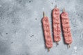 Raw Turkish Adana shish kebab on butcher table. Gray background. top view. Copy space Royalty Free Stock Photo