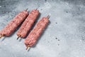 Raw Turkish Adana shish kebab on butcher table. Gray background. top view. Copy space Royalty Free Stock Photo