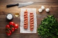Raw Turkish Adana shish kebab on white cooking paper and wooden table Royalty Free Stock Photo