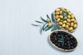 Raw turkish green and black olive seeds, olive tree branch with leaves on white table Royalty Free Stock Photo