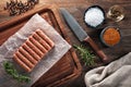 Raw Turkish inegol meatballs on white cooking paper and wooden table