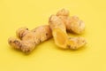 raw turmeric root slices isolated on yellow background Royalty Free Stock Photo