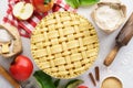 Raw unbaked apple pie with tools and ingredients for cooking Royalty Free Stock Photo