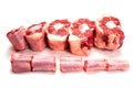 Raw uncooked beef oxtail cut into portions on white isolated background. Butcher craft. Meat industry product. Soup and stew Royalty Free Stock Photo