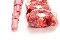 Raw uncooked beef oxtail cut into portions on white isolated background. Butcher craft. Meat industry product. Soup and stew Royalty Free Stock Photo