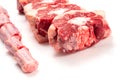 Raw uncooked beef oxtail cut into portions on white isolated background. Butcher craft. Meat industry product. Soup and stew Royalty Free Stock Photo