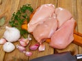 Raw uncooked chicken breast fillet with garlic and greens Royalty Free Stock Photo