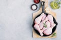 Raw uncooked chicken legs with rosemary and spices in cast iron pan Royalty Free Stock Photo