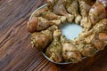 Raw uncooked chicken legs on round plate  with onion, tomato  and garlic Royalty Free Stock Photo