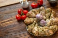 Raw uncooked chicken legs on round plate  with onion, tomato  and garlic Royalty Free Stock Photo