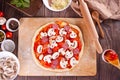 raw uncooked dough pizza and ingredients for pizza on the wooden background Royalty Free Stock Photo