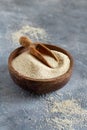 Raw uncooked fonio seeds in a bowl with a spoon on grey background Royalty Free Stock Photo