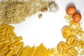 Raw uncooked Italian spaghetti, pasta, caneloni, fettuccine nests, noodles postcard background border frame on white Royalty Free Stock Photo