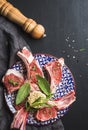 Raw uncooked lamb chops with herbs and spices on colorful plate over dark wooden background Royalty Free Stock Photo