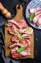 Raw uncooked lamb chops with herbs and spices on rustic wooden board over dark background Royalty Free Stock Photo