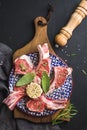 Raw uncooked lamb chops with herbs and spices on wooden board over dark background Royalty Free Stock Photo