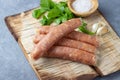 Raw uncooked meat sausages and green herbs Royalty Free Stock Photo