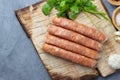 Raw uncooked meat sausages and green herbs. Royalty Free Stock Photo