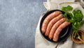 Raw uncooked meat sausages and green herbs Royalty Free Stock Photo