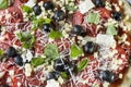 Raw uncooked pizza with pepperoni salami, black olives, basil and cheese Royalty Free Stock Photo