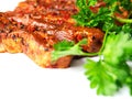 Raw uncooked pork belly slices marinated with Korean style souse and herbs and fresh coriander leafs on a white surface, Meat