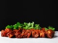 Raw uncooked pork belly slices marinated with Korean style souse and herbs and fresh coriander leafs on a white surface, Meat