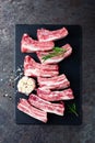 Raw uncooked pork ribs, fresh meat on dark metal background. Top view Royalty Free Stock Photo