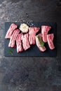 Raw uncooked pork ribs, fresh meat on dark metal background. Top view Royalty Free Stock Photo