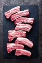 Raw uncooked pork ribs, fresh meat on dark metal background. Top view Royalty Free Stock Photo
