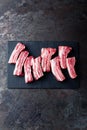 Raw uncooked pork ribs, fresh meat on dark metal background. Top view Royalty Free Stock Photo