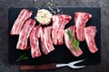 Raw uncooked pork ribs, fresh meat on dark metal background. Top view Royalty Free Stock Photo