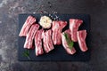 Raw uncooked pork ribs, fresh meat on dark metal background. Top view Royalty Free Stock Photo