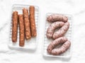 Raw uncooked turkey and spicy smoked paprika pork homemade sausages on light background, top view. Food ingredients Royalty Free Stock Photo