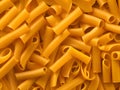 raw uncooked yellow italian pasta as background